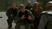 Daniel, Teal'c, Edwards, Major Lorne und Chaka knien vor Kor Asek nieder.